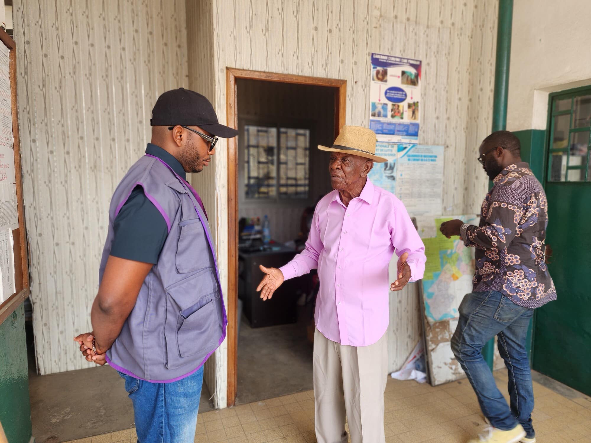86-year-old health worker Noe (pink shirt) chats with a colleague during a Mother and Child Health and Nutrition Action Week in Deido, Cameroon