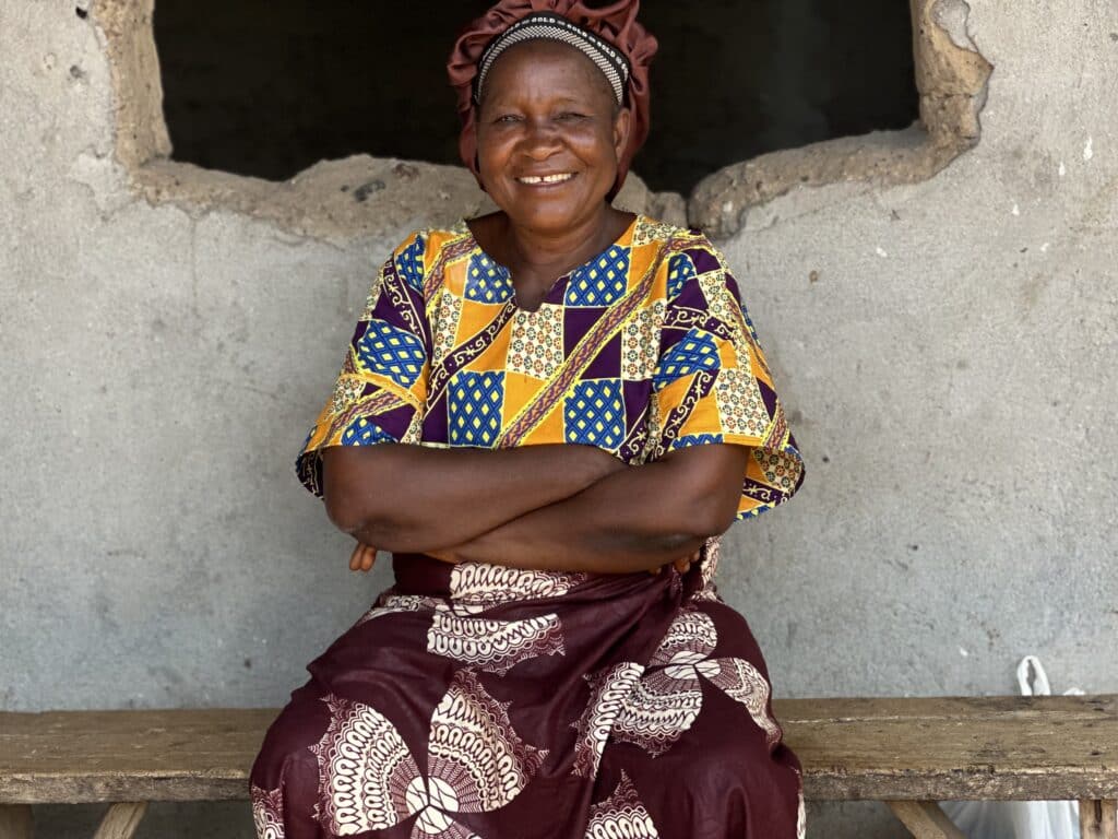 Aunty Sento sits in front of her house in rural Makeni, Northern Sierra Leone