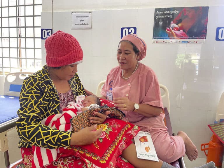 Mother holds newborn at lactation consultant office
