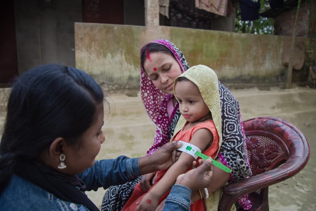 Community nutrition volunteer conducts a home visit to do a follow-up screening for a child diagnosed with acute malnutrition